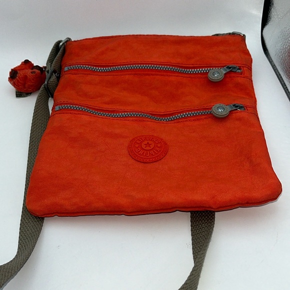 Kipling Handbags - Orange / Red Kipling Crossbody bag purse with monkey keychain